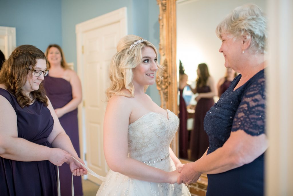 Bride Getting Ready Lace Up | Classic Purple & Orange Wedding Football Texas Longhorns Sports Lake Lucerne Courtyard Anna Christine Events Orlando Kathy Thomas Photography