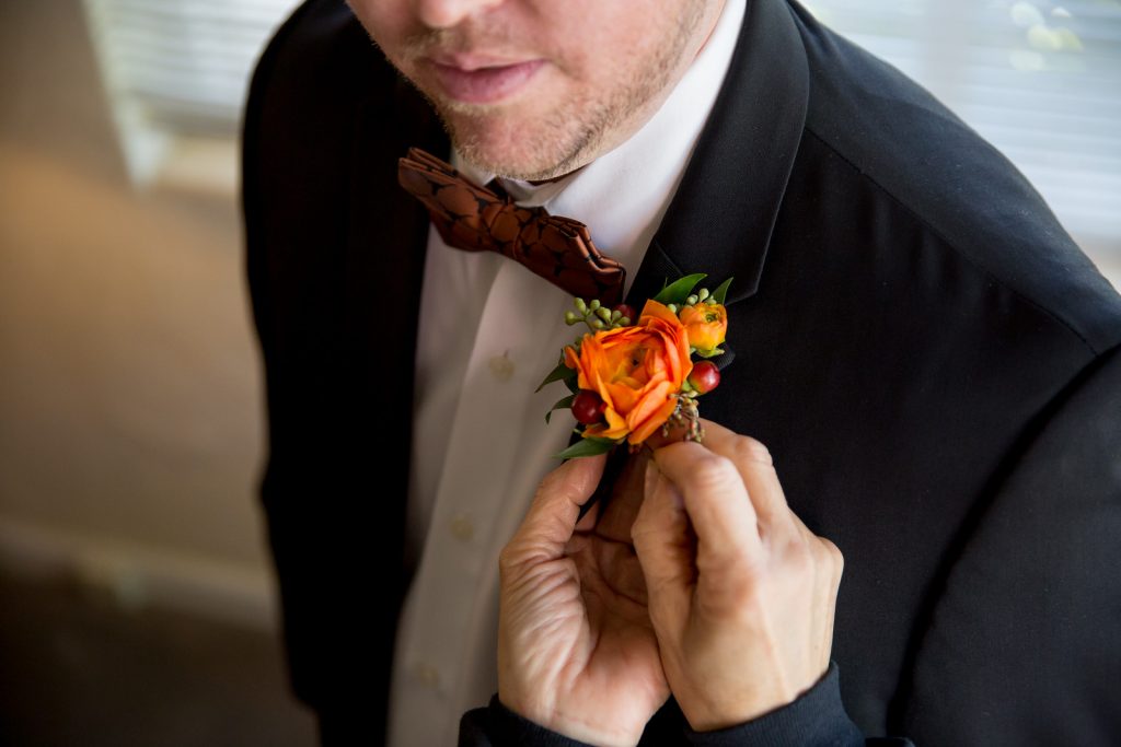 Flowers by Lesley Groom Boutonniere Orange | Classic Purple & Orange Wedding Football Texas Longhorns Sports Lake Lucerne Courtyard Anna Christine Events Orlando Kathy Thomas Photography
