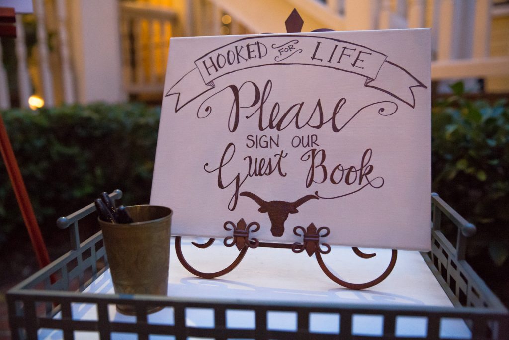 Football Jersey Guestbook Signing | The Courtyard at Lake Lucerne Classic Purple & Orange Wedding Football Texas Longhorns Sports Lake Lucerne Courtyard Anna Christine Events Orlando Kathy Thomas Photography