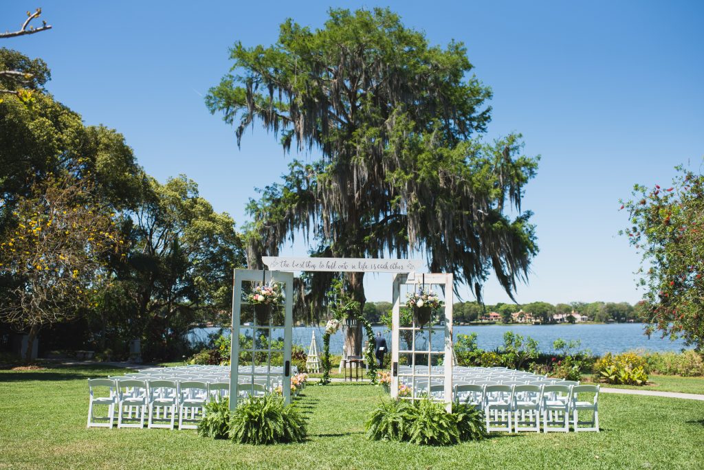 ceremony chairs and altar set up in front of lake at capen house wedding