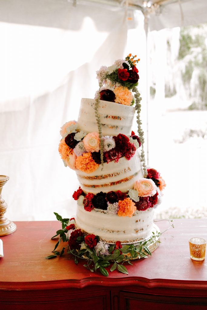 cake stacked in different directions decorated with flowers